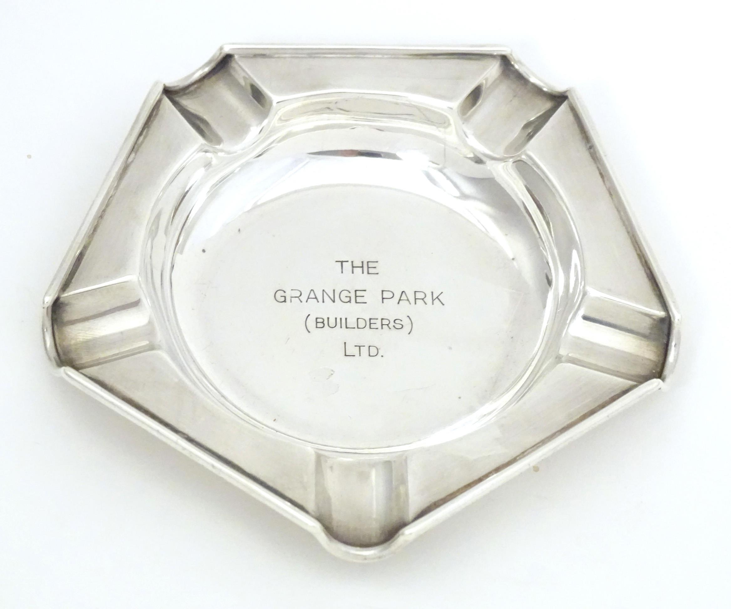 An Art Deco silver ashtray engraved to centre The Grange Park (Builders Ltd.) hallmarked London