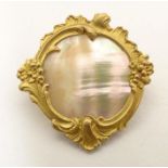 A late 19th / early 20thC gilt metal brooch set with mother of pearl to centre. Approx. 1 1/4"