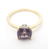 A 9ct gold ring set with blueberry quartz to centre. Ring size approx R Please Note - we do not make