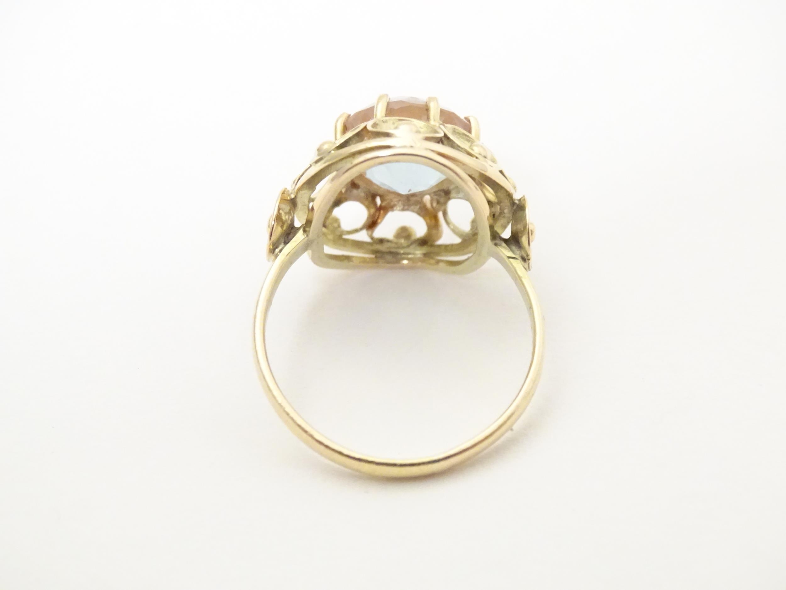 A Continental yellow metal ring set with facet saphiret glass to top. The ring approx size Q. Please - Image 7 of 7