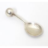 A silver caddy spoon with spherical finial to handle, hallmarked London 2004, maker TPTE. Approx. 3"