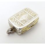 A Geo III silver vinaigrette with engrave decoration opening to reveal gilded grille and interior.