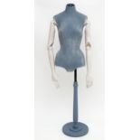 A female mannequin / dressmaker's dummy by Proportion London, on a turned wooden stand. Labelled