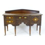 A late 19thC Anglo-Indian sideboard with a profusely detailed carved carcass and drawer fronts, a