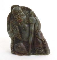 A Chinese carved jade figure depicting a man holding a fan and a staff. Approx. 6 1/4" high Please
