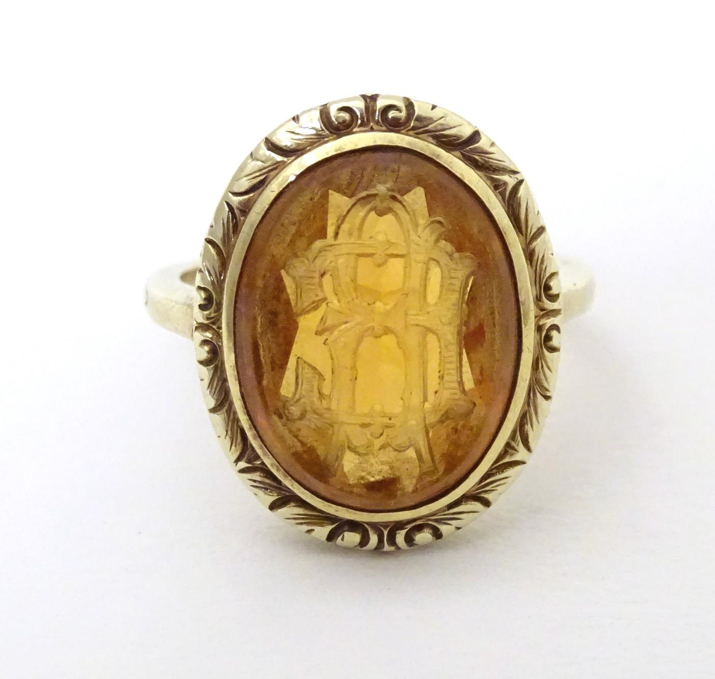 A late 19th / early 20thC yellow metal ring with engraved citrine seal to top depicting monogram. - Image 5 of 6