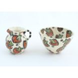 A studio pottery jug and bowl decorated with hand painted strawberry detail by Liz Riley. Marked