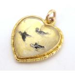 A gold sweetheart pendant locket of heart form set with Essex crystal cabochon depicting three