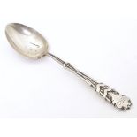 A silver teaspoon the handle with gold club and ball decoration and engraved HGC, possible for