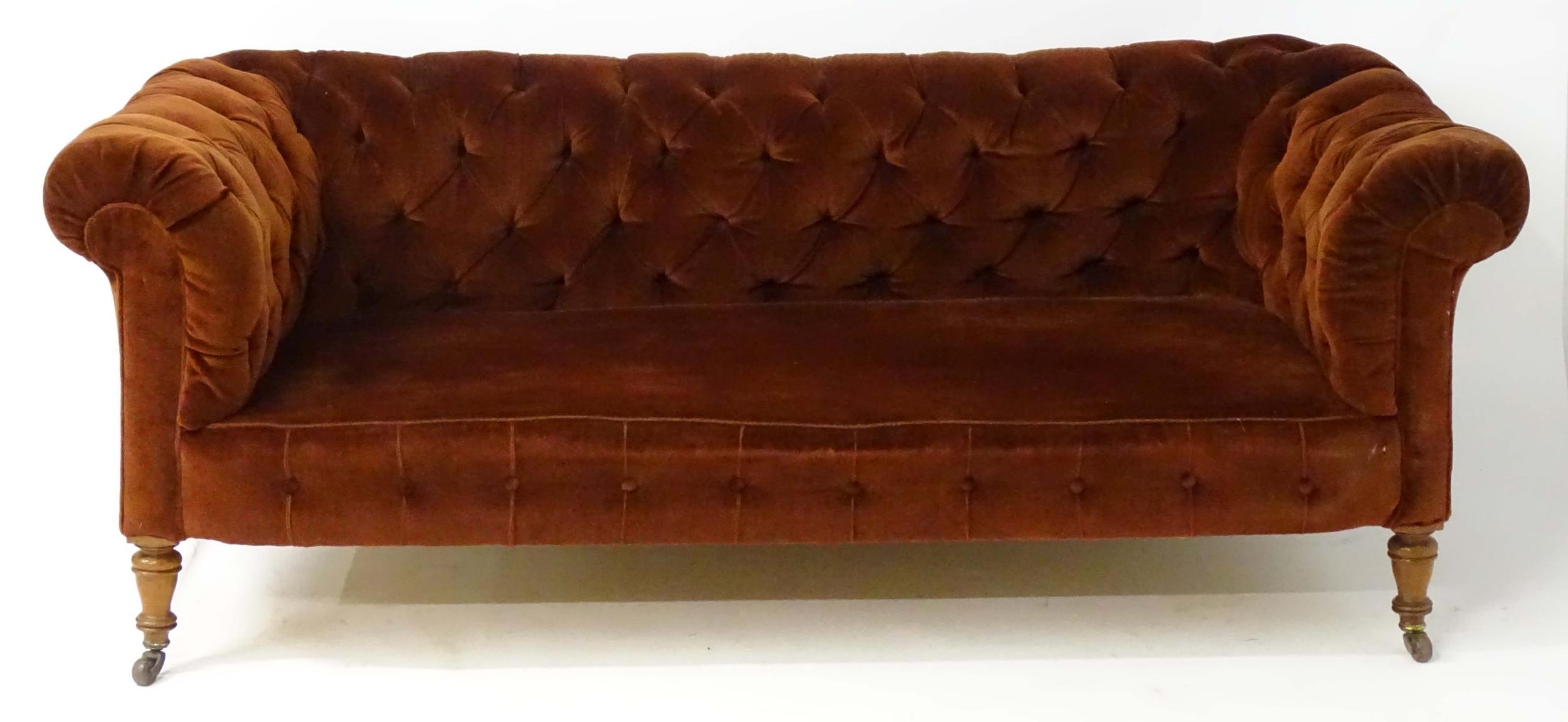 A late 19thC button back chesterfield sofa raised on turned tapering front legs. 81" wide x 37" deep - Image 3 of 5