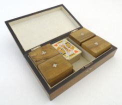 Toys: A late Victorian walnut games box, the hinged lid with inlaid playing cards, opening to reveal