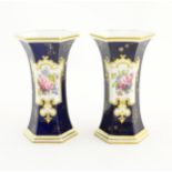 A pair Royal Crown Derby vases of hexagonal flared form with hand painted floral vignettes signed