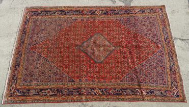 Carpet / rug : A Bidjar carpet, the red and blue ground decorated with floral, foliate and geometric