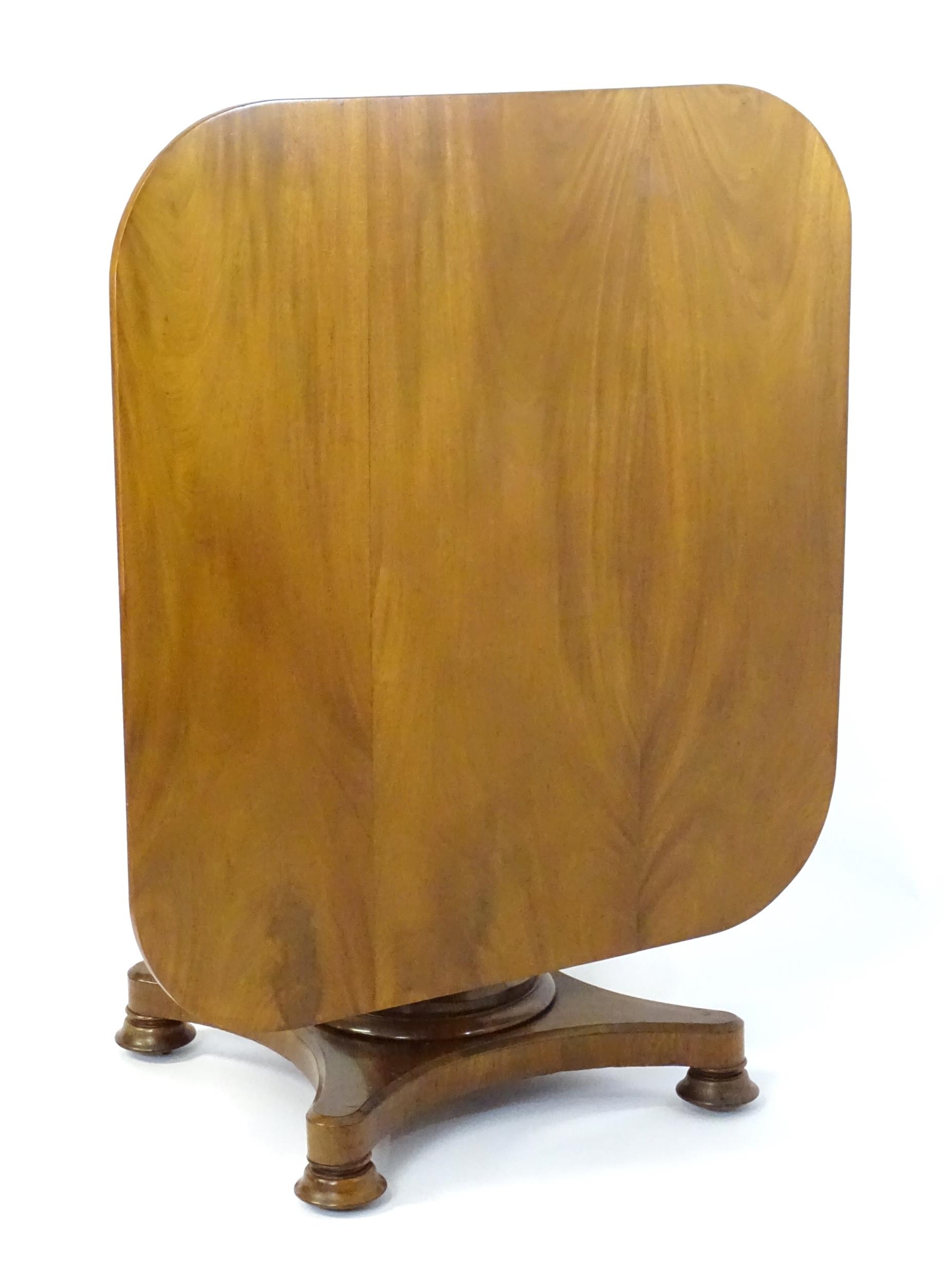 A Victorian mahogany tilt top table with rounded edges and standing on a pedestal base with - Image 2 of 8