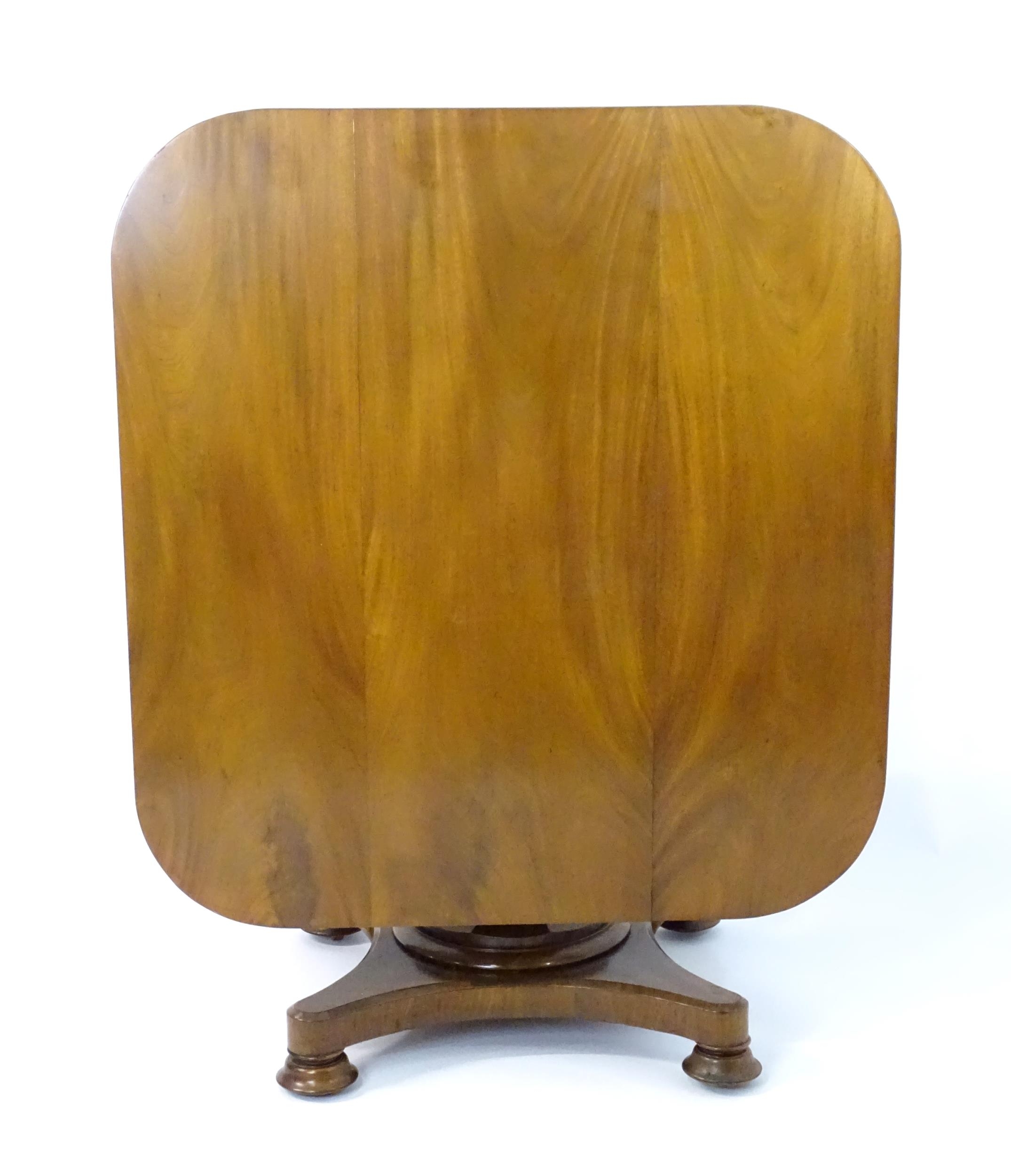 A Victorian mahogany tilt top table with rounded edges and standing on a pedestal base with - Image 4 of 8