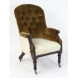 A 19thC armchair with a rounded top and deep buttoned backrest above scrolled arms and tapering