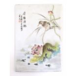 A Chinese porcelain plaque decorated with a bird perched on the stem of a stylised flower. Character