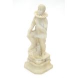 A late 19th / early 20thC Continental carved alabaster sculpture depicting a pierrot / theatrical