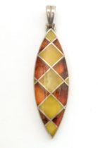 A silver pendant set with amber detail 1 1/2" long Please Note - we do not make reference to the