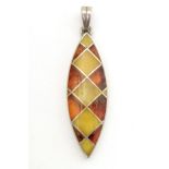 A silver pendant set with amber detail 1 1/2" long Please Note - we do not make reference to the