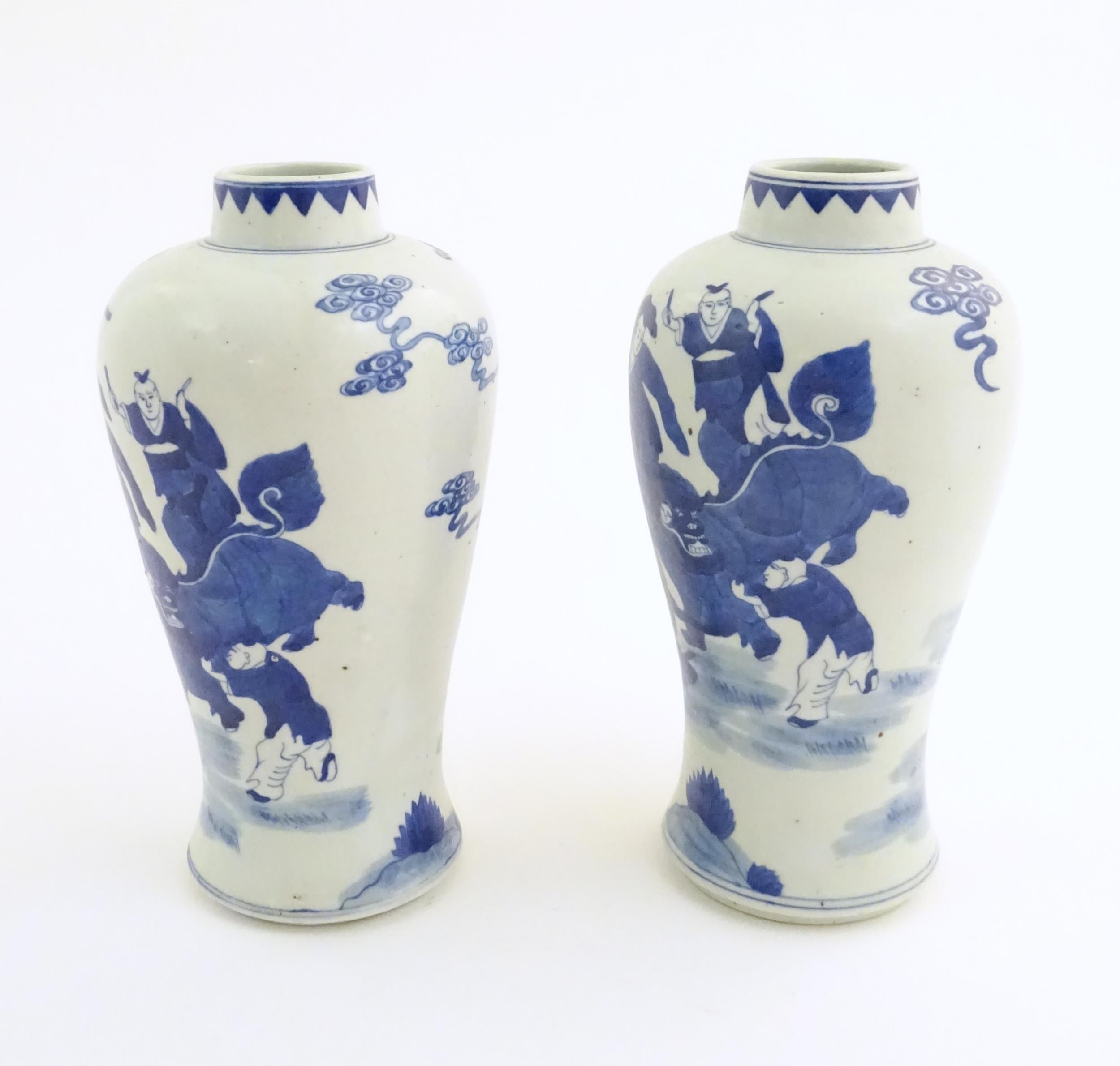 A pair of Chinese blue and white vases decorated with a Chinese dragon parade with figures in a - Image 3 of 6