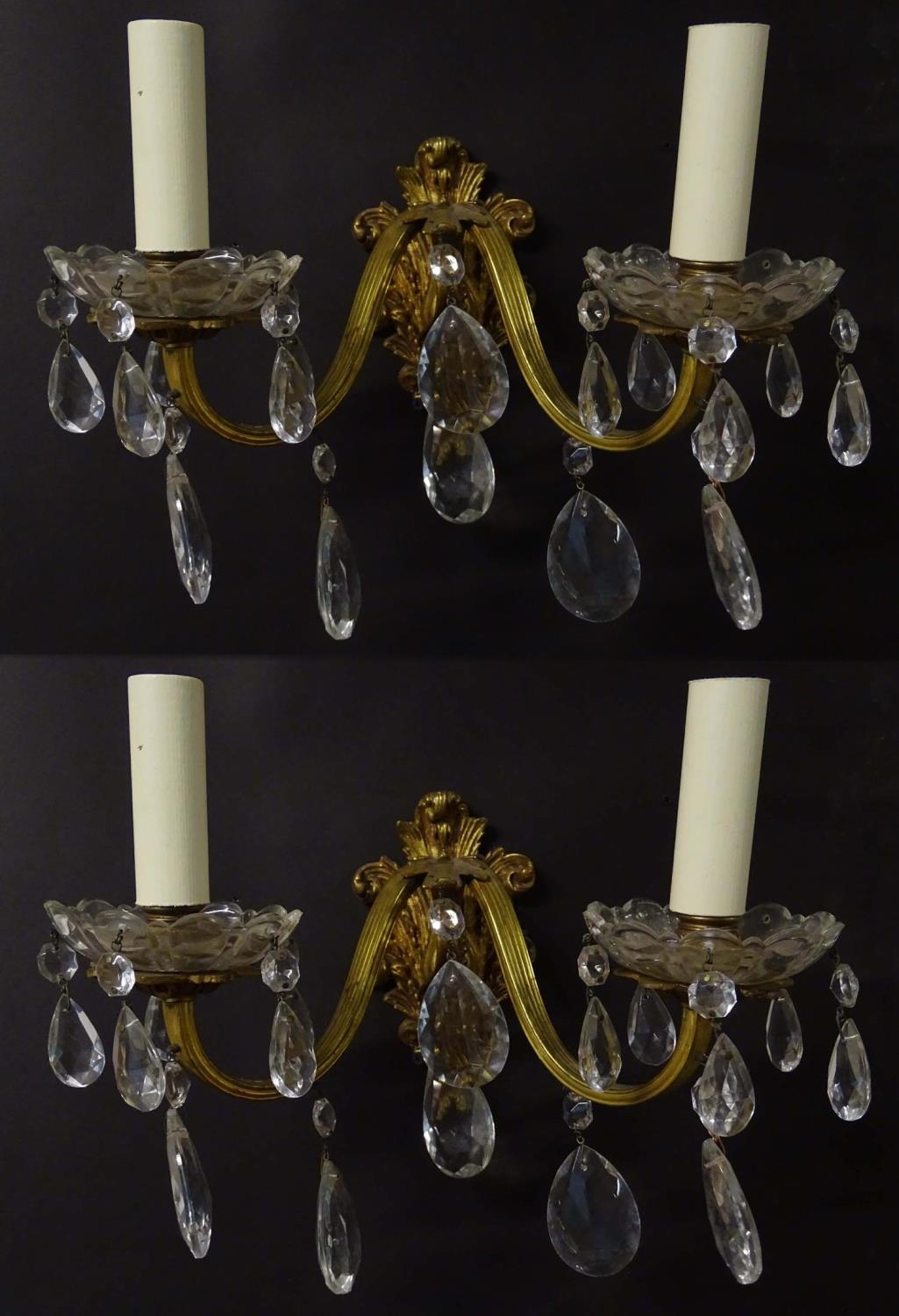 A pair of 20thC gilt twin branch wall lights, the gilt mounts supporting cut glass cups with