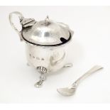 A silver mustard pot with blue glass liner and associated mustard spoon. Hallmarked Birmingham