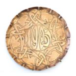 An Art Nouveau copper card tray with embossed decoration depicting stylised flowers and foliage,