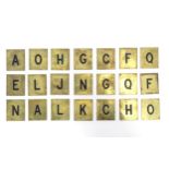A quantity of 20thC brass plaques each with an enamel letter, comprising A, O, H, G, C, F, Q, E,