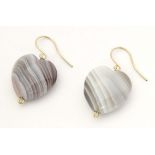 A pair of drop earrings set with banded agate hardstone drop of heart form. Approx. 1 1/2" long