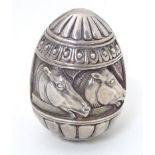 A Continental white metal desk weight of egg form with horse head detail. Marked under Made in