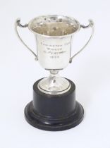 An Art Deco miniature silver twin handled trophy cup with socle base, hallmarked London 1937,