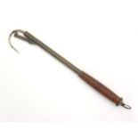 An early to mid 20thC telescopic fishing gaff, with turned wooden handle and folding hook guard.
