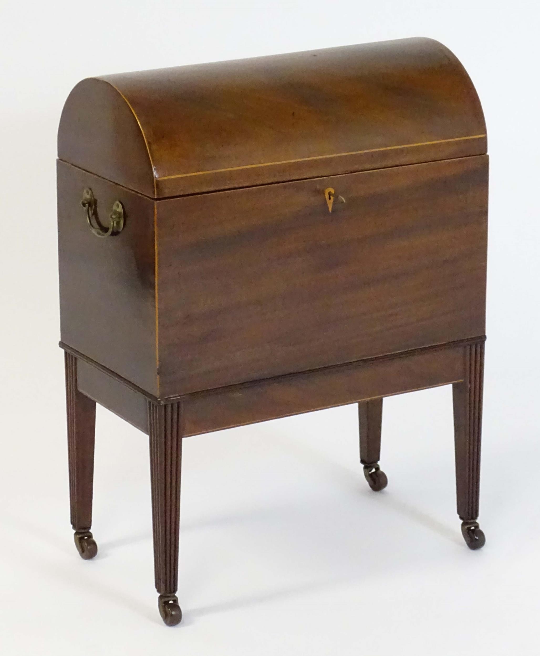 A George III mahogany domed lidded cellarette fitted with dividers for eight bottles, flanked by - Image 8 of 10