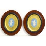 A pair of 19thC Wedgwood jasperware blue and white oval plaques depicting classical maidens, one