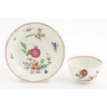 An English late 18th / early 19thC tea bowl and saucer with hand painted floral decoration. In the