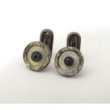 A pair of dress studs marked 900 and set with sapphire cabochon to centre. 1/4" diameter Please Note