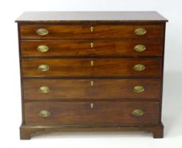A late Georgian mahogany secretaire chest of drawers with a rectangular top above four graduated