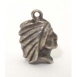 A white metal pendant charm formed as the head of a Native American Indian. Approx. 1/2" long Please