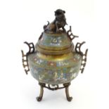 A Chinese three footed brass censer, the body with enamel decoration depicting birds, flower and