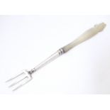 A white metal pickle fork with mother of pearl handle. Approx. 5" long Please Note - we do not