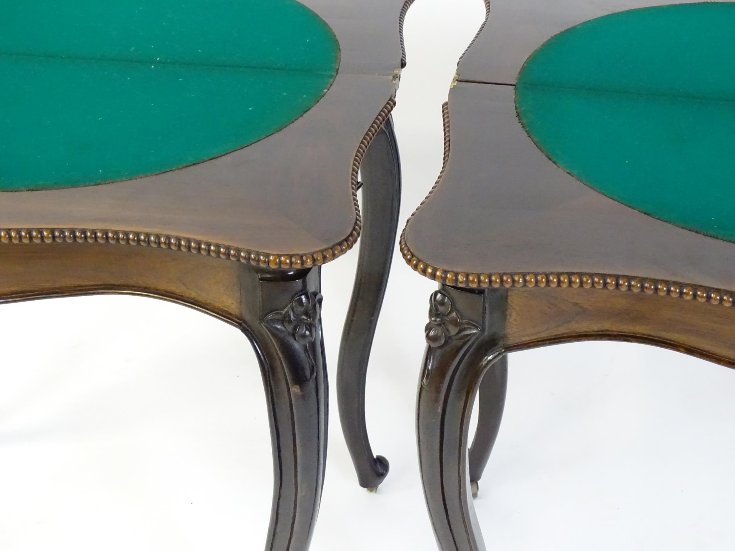 A pair of 19thC rosewood card tables of serpentine form, having beaded edges above floral carved - Image 16 of 18