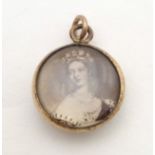 A Victorian double sided pendant set with images of Queen Victoria. Approx. 3/4" long Please