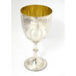 A Victorian silver trophy cup of goblet form with engraved fern detail and gilded interior,