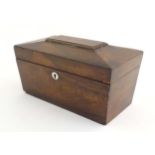 A 19thC mahogany tea caddy of sarcophagus form with mother of pearl escutcheon. The fitted