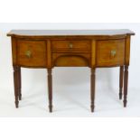 A Regency period mahogany sideboard of narrow proportions with ebony and satinwood stringing to