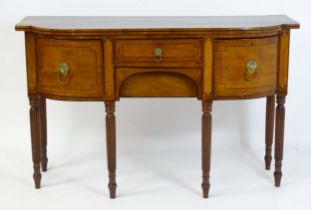 A Regency period mahogany sideboard of narrow proportions with ebony and satinwood stringing to