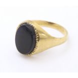 A gentleman's 9ct gold signet ring set with onyx. Ring size approx. X 1/2 Please Note - we do not