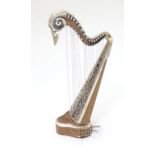 A silver model of a harp by Sachetti . Approx. 5" high Please Note - we do not make reference to the