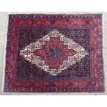 Carpet / Rug : A Senneh rug with blue, red and cream grounds and banded detail. Approx. 48" x 61"